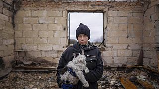 Danyk Rak, 12, holds a cat standing on the debris of his house destroyed by Russian forces' shelling in the outskirts of Chernihiv, Ukraine, Wednesday, April 13, 2022.
