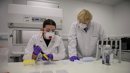 File - UK Prime Minister Boris Johnson visits the lab of French biotech Valneva in Livingston, Scotland, on January 28, 2021.