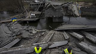 Engineers inspect the state of destruction of the bridge that connects Kyiv with Irpin