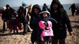 Migrants walk up the shore after being rescued by the RNLI (Royal National Lifeboat Institution) while crossing the English Channel, in Dungeness, Britain, March 15, 2022.