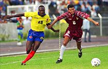 Colombian player Freddy Rincon, left, fights for the ball with Elvis Martinez of Venezuela during a qualifying France '98 game in San Cristobal, Venezuela