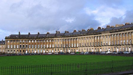 The elegant Georgian architecture of the Royal Crescent, a series of mansions built in a semicircle in the late 1700s in Bath, England.