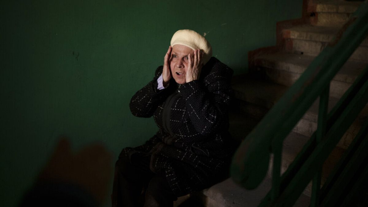 A woman reacts next to the body of a 15-year-old boy killed during a Russian attack in Kharkiv, Ukraine, Friday, April 15, 2022.