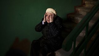 A woman reacts next to the body of a 15-year-old boy killed during a Russian attack in Kharkiv, Ukraine, Friday, April 15, 2022.