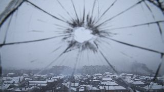 A hospital window is cracked from shelling in Mariupol.