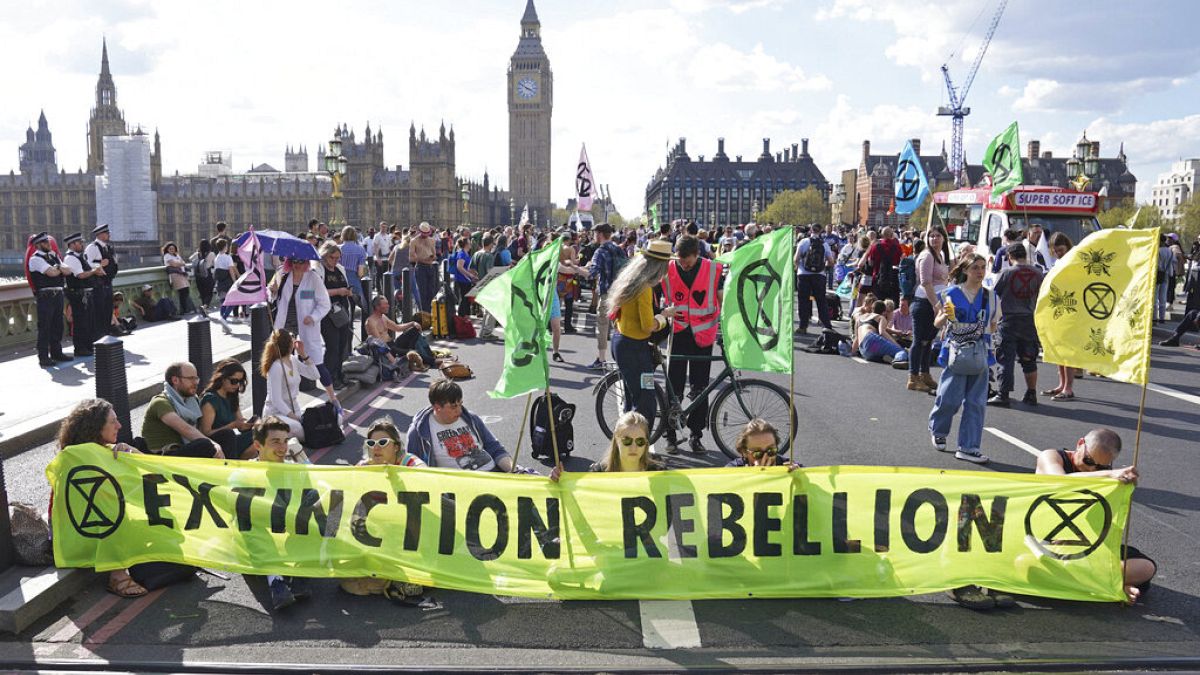 Demonstrators take part in an Extinction Rebellion protest on Westminster Bridge in London, Friday, April 15, 2022. 