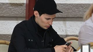 FILE - In this Saturday May 19, 2012 file photo, Pavel Durov, founder of Russia's leading social network site VKontakte, or "in contact", sits in a cafe in Red Square in Mosco