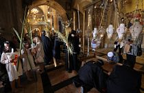 Orthodox Christians gather around the Stone of Anointing, the place believed to be where Jesus Christ's body was laid after being taken down from the cross.