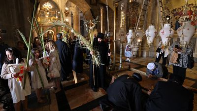 Orthodox Christians gather around the Stone of Anointing, the place believed to be where Jesus Christ's body was laid after being taken down from the cross.