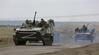 Russian military vehicles move on a highway in an area controlled by Russian-backed separatist forces near Mariupol on 18 April 2022