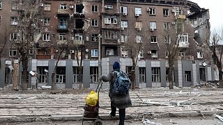 A local resident looks at a damaged apartment building in an area controlled by Russian-backed separatist forces in Mariupol, Ukraine. 16 April 2022