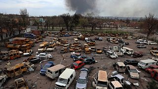 Damaged and burned vehicles are seen at a destroyed part of a plant in an area controlled by Russian-backed separatist forces in Mariupol