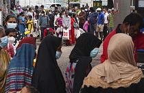 Sri Lankans queue up near a fuel station to buy kerosene in Colombo