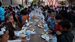 Syrian orphaned children having a fast-breaking iftar meal