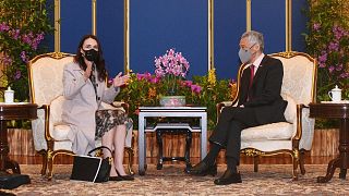 New Zealand's Prime Minister Jacinda Ardern (L) gestures as she talks with her Singaporean counterpart Lee Hsien Loong during a meeting at the Istana presidential palace.