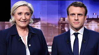 French presidential candidates Marine Le Pen (L) and Emmanuel Macron (R) prior to a live televised debate, May 3, 2017.