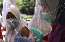 A health workers prepares an HPV vaccine shot for a student in Jakarta, Indonesia