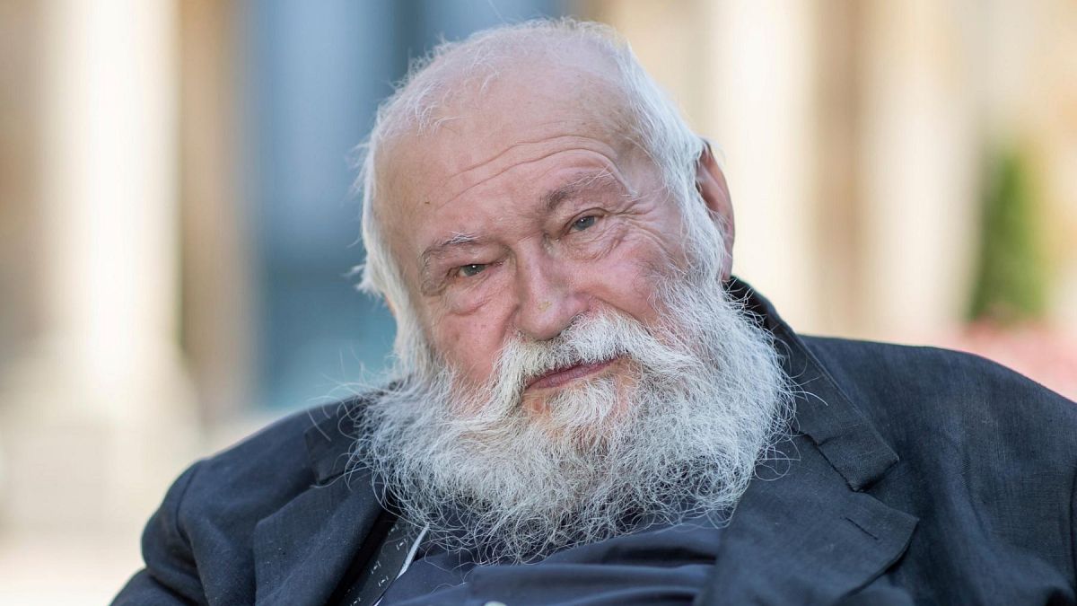 FILE -Action artist Hermann Nitsch sits in front of the Festspielhaus in Bayreuth, Germany, July 23, 2021.