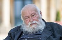 FILE -Action artist Hermann Nitsch sits in front of the Festspielhaus in Bayreuth, Germany, July 23, 2021.