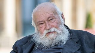 FILE -Action artist Hermann Nitsch sits in front of the Festspielhaus in Bayreuth, Germany, July 23, 2021.