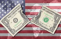 Composite image shows a dollar bill against the backdrop of a US flag and overlaid map of the world.