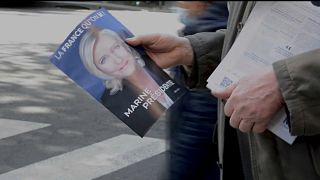 Campaigner hands out Marine Le Pen poster