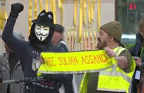 Outside the court, protesters held aloft placards imploring "Don't extradite Assange" and attached yellow #FreeAssange ribbons to walls outside the court.