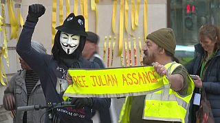 Outside the court, protesters held aloft placards imploring "Don't extradite Assange" and attached yellow #FreeAssange ribbons to walls outside the court.