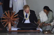 Prime Minister Boris Johnson tries to spin a cotton thread