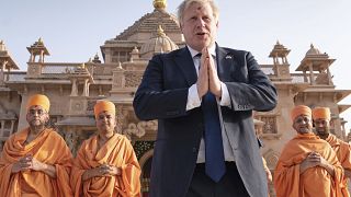Boris Johnson walks with sadhus, Hindu holymen, as he visits the Swaminarayan Akshardham temple in Gandhinagar, Ahmedabad, part of his two-day trip to India, April 21, 2022.