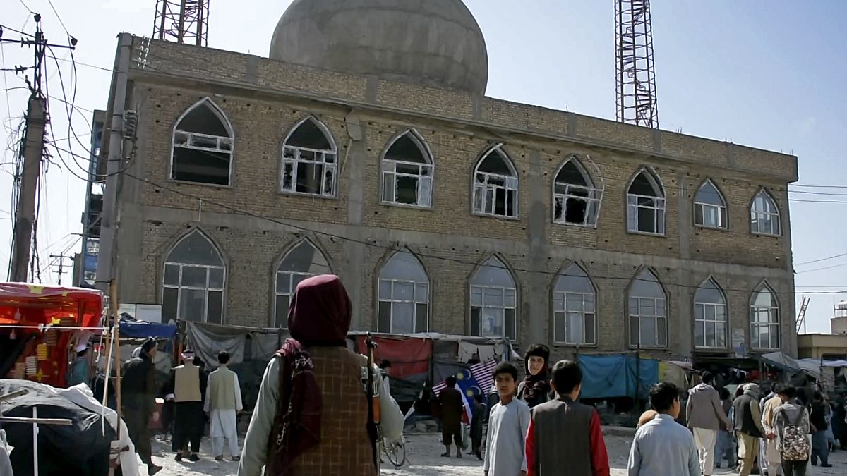 A Taliban fighter stands guard outside a mosque in Mazar-e-Sharif province.