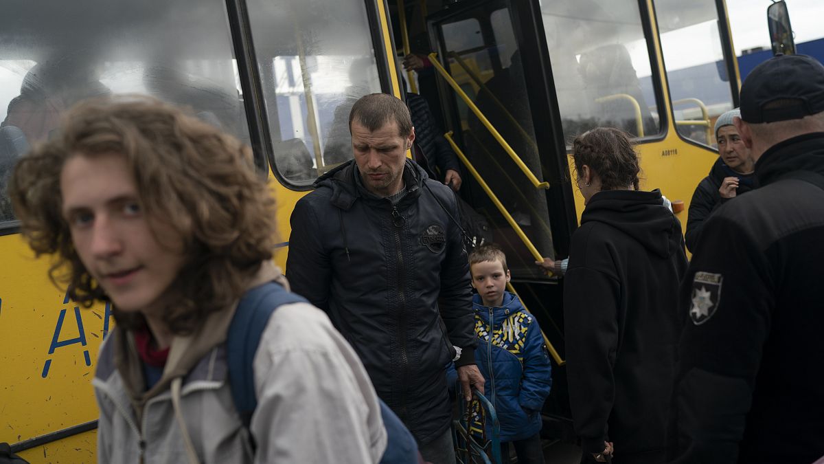 Internally displaced people from Mariupol arrive at a refugee center fleeing from the Russian attacks, in Zaporizhzhia, Ukraine, Thursday, April 21, 2022.