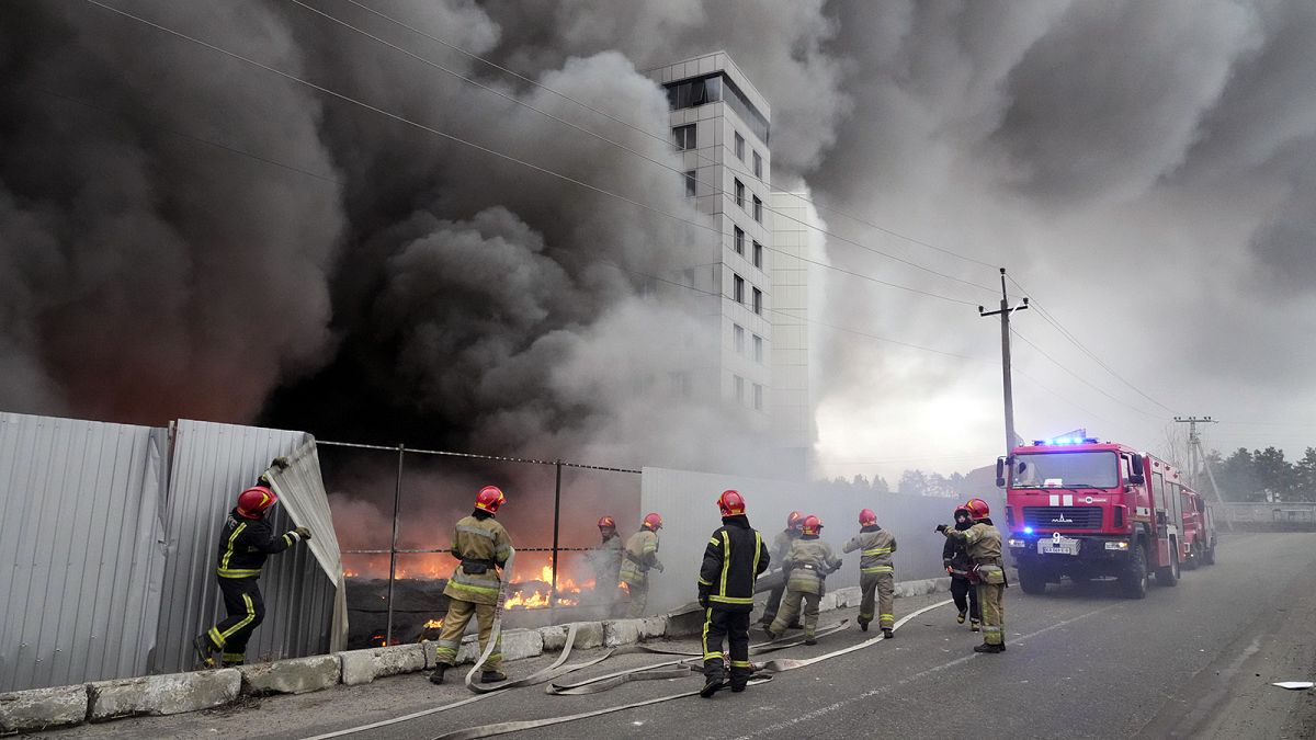 Firefighters work to extinguish a fire at a damaged logistic center after shelling in Kyiv, 3 March 2022