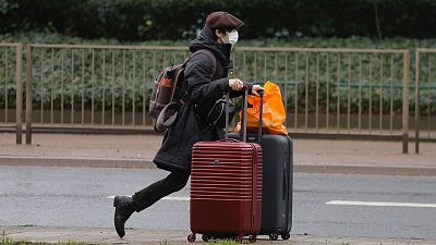 A traveller walks with luggage near London's Heathrow Airport.