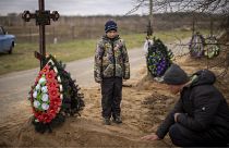 Десятилетний мальчик на похоронах своей матери, погибшей в Буче во время оккупации.