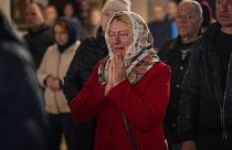 Olga Zhovtobrukh, 55, cries during an Easter religious service celebrated at a church in Bucha on 24 April 2022