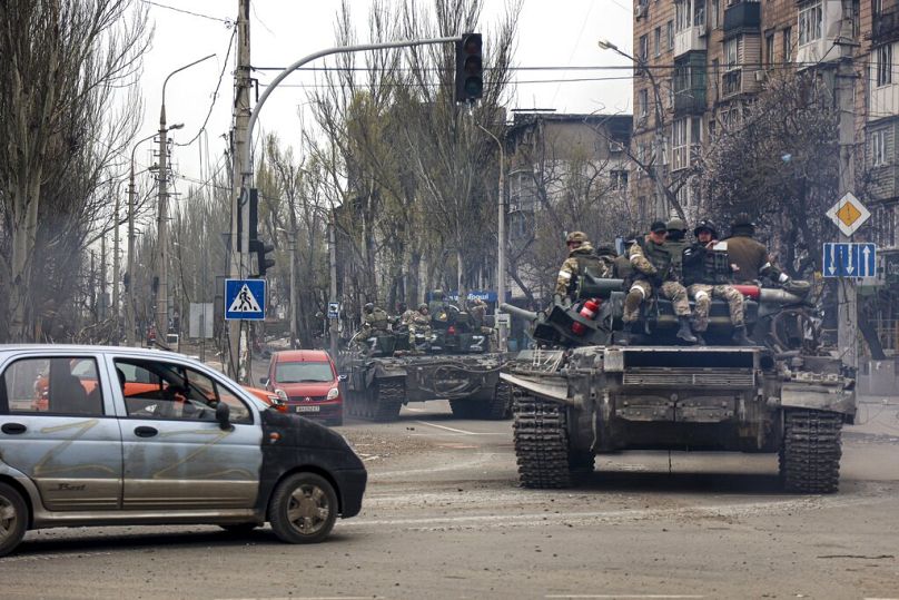 Russian tanks roll along a street in an area controlled by Russian-backed separatist forces in Mariupol, Ukraine, Saturday, April 23, 2022.
