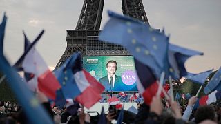 Supporters of French President Emmanuel Macron celebrate reports of his victory Sunday, April 24, 2022 in Paris.
