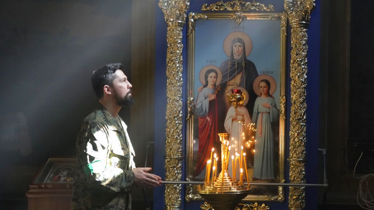A Ukrainian soldier prays in St. Michael Cathedral during Easter celebration in Kyiv, Ukraine, Sunday, April 24, 2022.