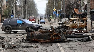 A part of a destroyed tank and a burned vehicle sit in an area controlled by Russian-backed separatist forces in Mariupol, Ukraine, Saturday, 23 April, 2022.