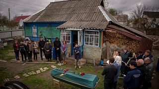 Relatives of Mykola Moroz, 47, gather during a funeral service at his home at the Ozera village, near Bucha, Ukraine, on Tuesday, April 26, 2022.