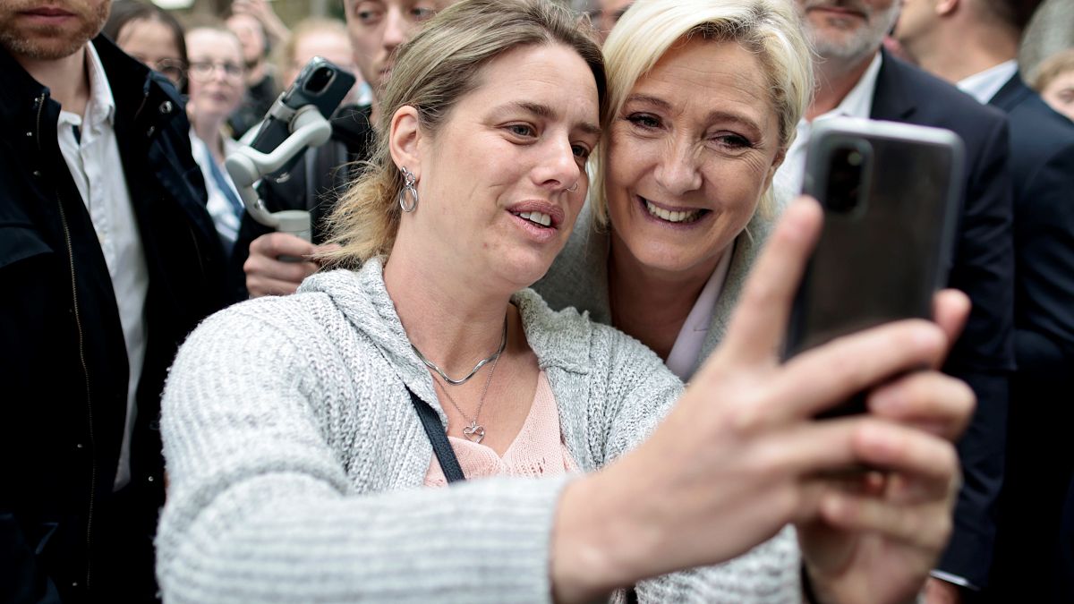 French candidate Marine Le Pen taking a selfie with a supporter