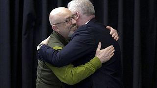Ukraine's Defence Minister Oleksii Reznikov, left, hugs a participant of the talks at Ramstein Air Base in Ramstein, Germany, Tuesday, April 26, 2022.
