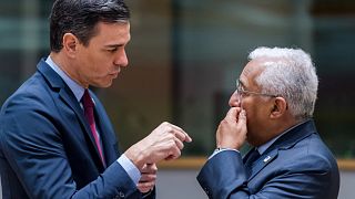 Spanish Prime Minister Pedro Sanchez, left, speaks with Portuguese Prime Minister Antonio Costa during a round table meeting at an EU summit in Brussels March 25, 2022.