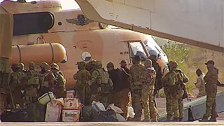 This undated photograph handed out by French military shows Russian mercenaries boarding a helicopter in northern Mali