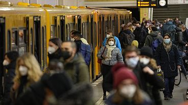 People wear face mask to protect against the coronavirus at the public transport station Friedrichstrasse in Berlin, Germany, Tuesday, November 30, 2021. 