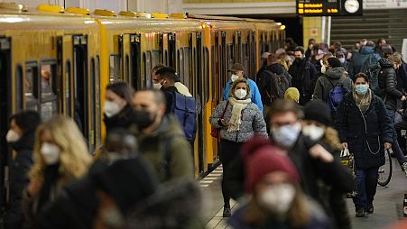 People wear face mask to protect against the coronavirus at the public transport station Friedrichstrasse in Berlin, Germany, Tuesday, November 30, 2021.