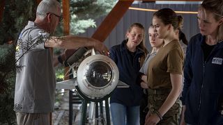 Demining instructor Artur Tigani, left, briefs a group of Ukrainian female emergency services personnel for specialist training in explosive ordnance disposal.