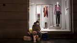 A woman wearing a face mask to protect against coronavirus, sells flowers on a warm winter evening at a Gediminas Avenue in Vilnius