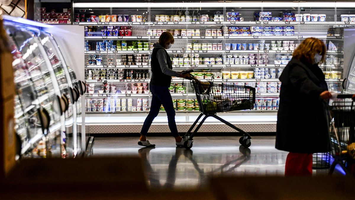  a customer pushing a shopping cart past the shelves during purchases at a supermarket in Duesseldorf, western Germany, on April 29, 2020.